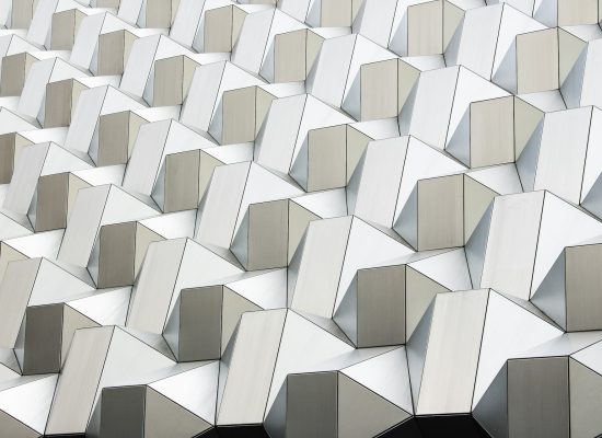 Geometric architectural panels with interlocking faceted structure illustrating the interconnected layers of an AI operating model